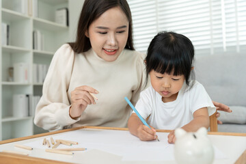 Mother day, Happy Asia mother play and learn drawing for little girl. Funny family is happy and excited in the house. Mother and daughter  having fun spending time together. Holiday, Activity