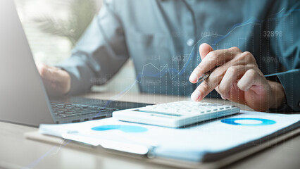 analysis, finance, investment, A businessman using a calculator and laptop analyzing financial data, showing charts and graphs representing accounting, investment, and business growth performance.