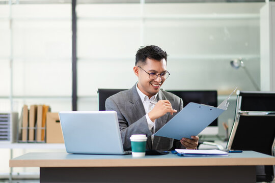 Business man using tablet and laptop for doing math finance on an office desk, tax, report, accounting, statistics,