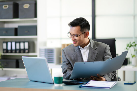 Business man using tablet and laptop for doing math finance on an office desk, tax, report, accounting, statistics,