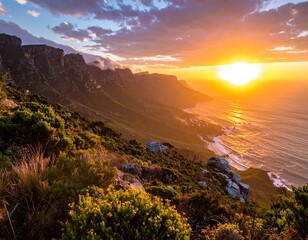 Golden sunset over mountain range meeting the ocean