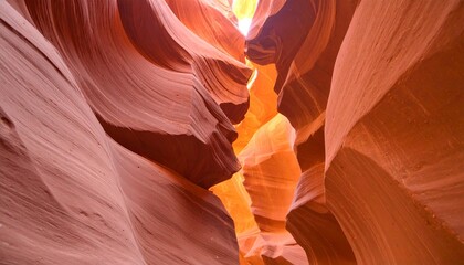 Explore the mesmerizing depths of Antelope Canyon with its smooth sandstone walls and the ethereal glow of natural light, a vibrant showcase of nature's artistic power and geological wonder