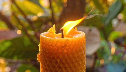 Close-up of a warm, glowing beeswax candle with a gently flickering flame and bokeh background