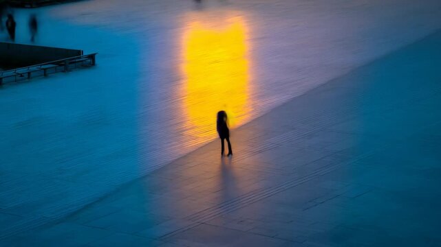 Mysterious figure standing alone in vibrant cityscape at dusk, ideal for mood and emotion themed projects