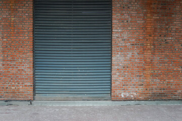 Large ventilation grill mounted in red brick wall.