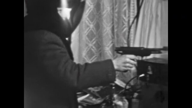 Gangster turns gun at partner points gun in sudden betrayal. Monday crimes in Parody scene. Mafia dramas with humorous. Black and white comedy. Vintage film. Old archive video. Archival retro 1960s