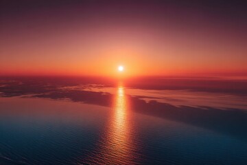 Fototapeta premium Wide aerial view of a stunning sunrise over the ocean reflecting warm hues and calm waters in a minimalistic setting