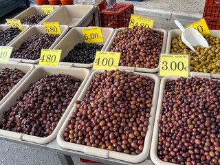Variety of olives displayed at a greek market stall