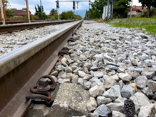 Close-up of railway track and gravel in countryside setting