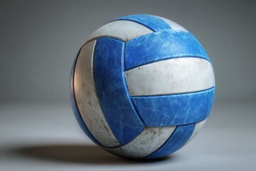 Realistic volleyball ball glyph on textured surface showcasing vibrant blue and white colors in a studio setting