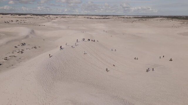Aerial footage of people sliding down in Lancelin Sand Dunes in Perth, Western Australia.