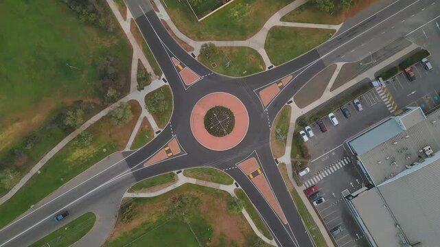 Aerial footage of traffic at a roundabout in Geraldton, Perth, Western Australia. The footage revolves around the roundabout as light traffic goes through the road intersection.
