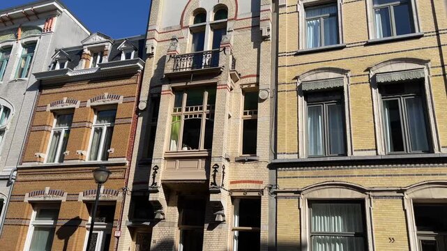 Row of charming, historic European townhouses with varied brick facades and architectural details in Antwerp, Belgium