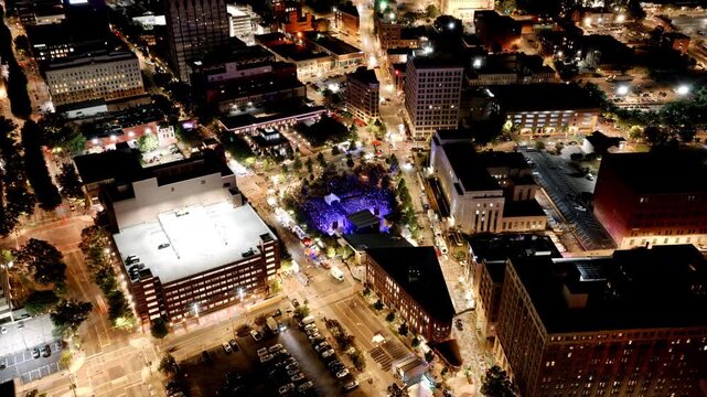 Downtown Chattanooga glowing at night as concert lights illuminate the plaza for the International Bluegrass Awards event.