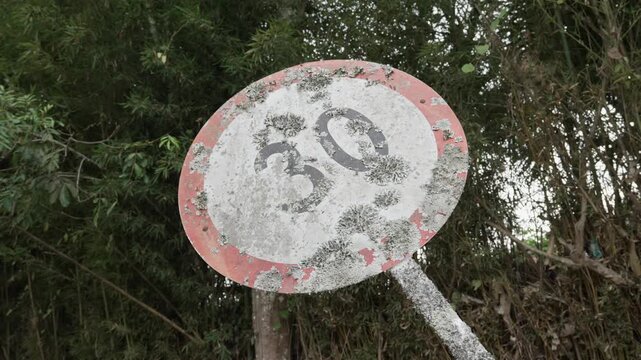 30 miles kilometers per hour red circle with a number inside speed limit sign old dirty