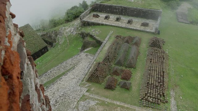 Piles of old, rusty cannonballs at Citadelle Laferri&egrave;re, historic military ammunition fortress in Haiti. High angle