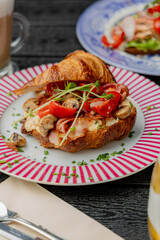 Croissant with filling on a beautiful plate isolated