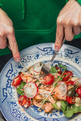 Girl cutting a croissant with a knife and fork