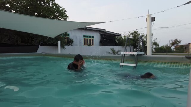 Kids swimming watched by their grandmother