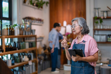 Mother, son and daughter are working at their DIY store.