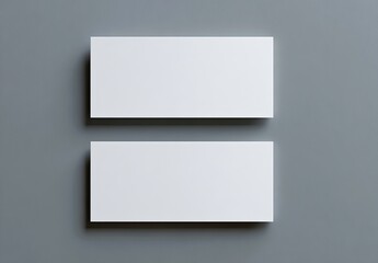 Two rectangular, white, business card mockups are stacked on a gray background