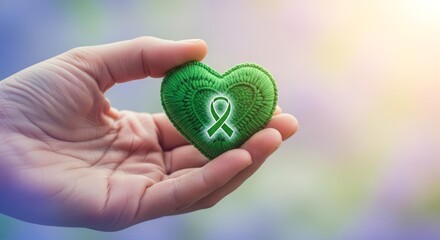 Hand Gently Holds Green Heart with Awareness Ribbon Symbolizing Support