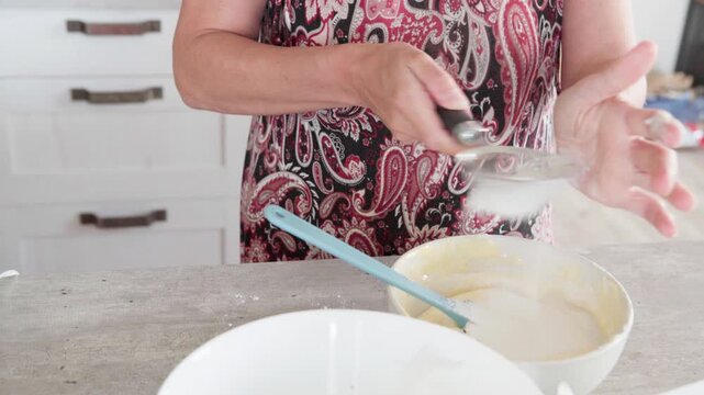 4K close-up video of dought being whisked in deep white bowl while making apple cake, homemade baking process, fresh ingredients, healthy food, nutritious dessert, cooking at home, nutrition concept