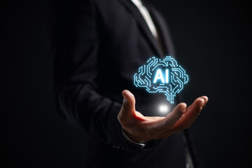 Businessman holding glowing AI brain icon, symbolizing artificial intelligence innovation, digital transformation, machine learning, and future technology in business data-driven decision making.