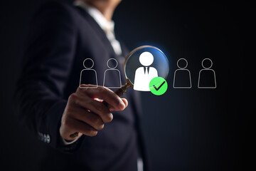 Businessman selecting candidate with magnifying glass, symbolizing recruitment, job search, human resources, hiring process, talent acquisition employee selection in modern workforce.
