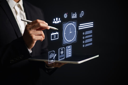 Businessman using digital tablet with virtual task icons for time management, project planning, productivity, team collaboration data analysis in modern workplace or remote work setting.