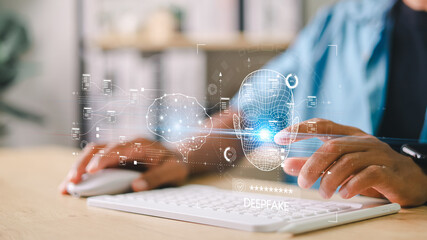 Deepfake detection and AI technology concept. Businessman using laptop and digital facial recognition interface for cybersecurity and identity verification.
