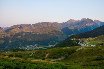Naklejka premium Panorama of the small Val Louron ski resort and surrounding mountains from the Col d’Azet at sunset in summer