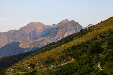 Naklejka premium Panoramic view of the green summer mountains at sunset from the Col d’Azet