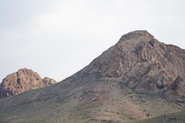 Mountainous terrain and various vegetation on the banks of the Ili River. National Nature Park.