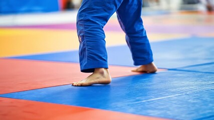Barefoot Person Walking on Martial Arts Mat - Powered by Adobe