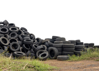 Low angle view of isolated piles of car tires left on the ground ready to be reused at a car repair shop, a common sight in rural Thailand.