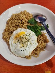 Fried egg noodles are a savory stir-fried dish where springy noodles meet eggs, vegetables, and aromatics, creating a warm, satisfying blend of smoky, salty, and lightly sweet flavors