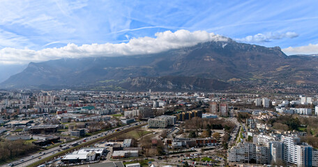 Modern cityscape with mountains and highway infrastructure