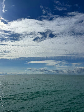Glittering sea and sky with beautiful clouds.