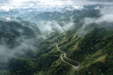 Winding mountain road through misty valley