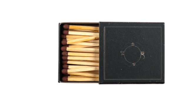Open matchbox exposing rows of wooden sticks with dark ends