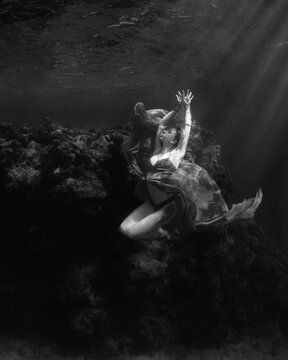 Woman floating underwater in the ocean on the Great Barrier Reef