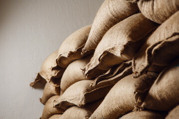 Storage of Raw Coffee Beans in a Warehouse With Burlap Sacks Stacked Neatly in Warm Lighting