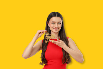 Woman in a red dress smiles with a golden cart