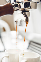 Close up of Brewing Espresso With Rich Crema in Professional Stylish Coffee Machine Over Bright Background 