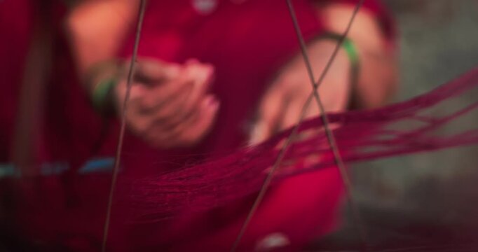 Traditional Indian woman weaving on a handloom at home &ndash; handmade textile art and cultural heritage
