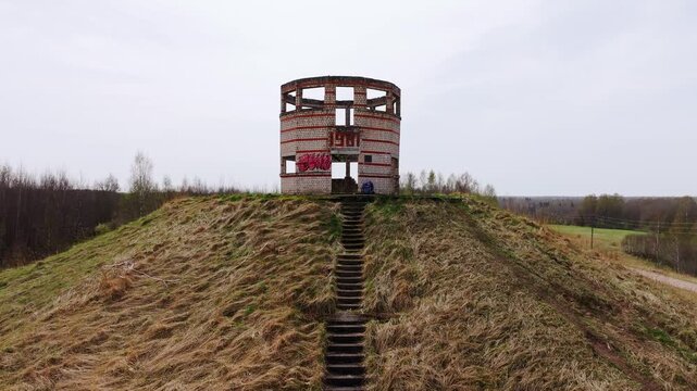Aerial footage brick tower ruins built in 1981 part of old Soviet missile base