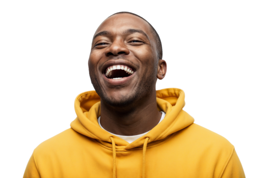 Smiling man in yellow hoodie expresses joy with bright laughter against plain background