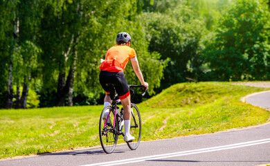 Fototapeta premium Cyclist ride on the bike path in the city Park 