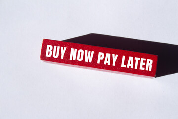 Buy now pay later message written on wooden block background. Conceptual Buy now pay later symbol....